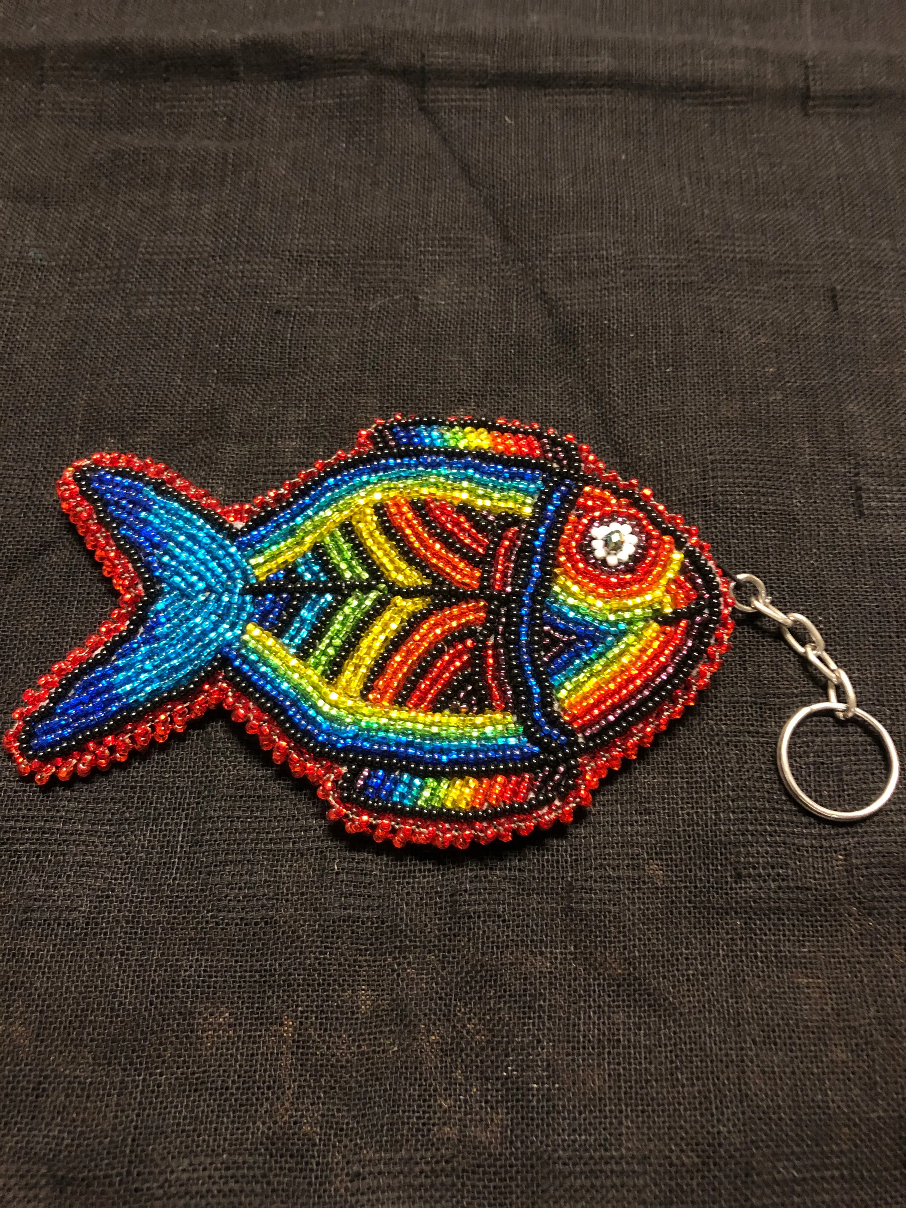 Guatemalan handcrafted glass bead round change purse with key ring. 3.5” diameter.  Fish design.